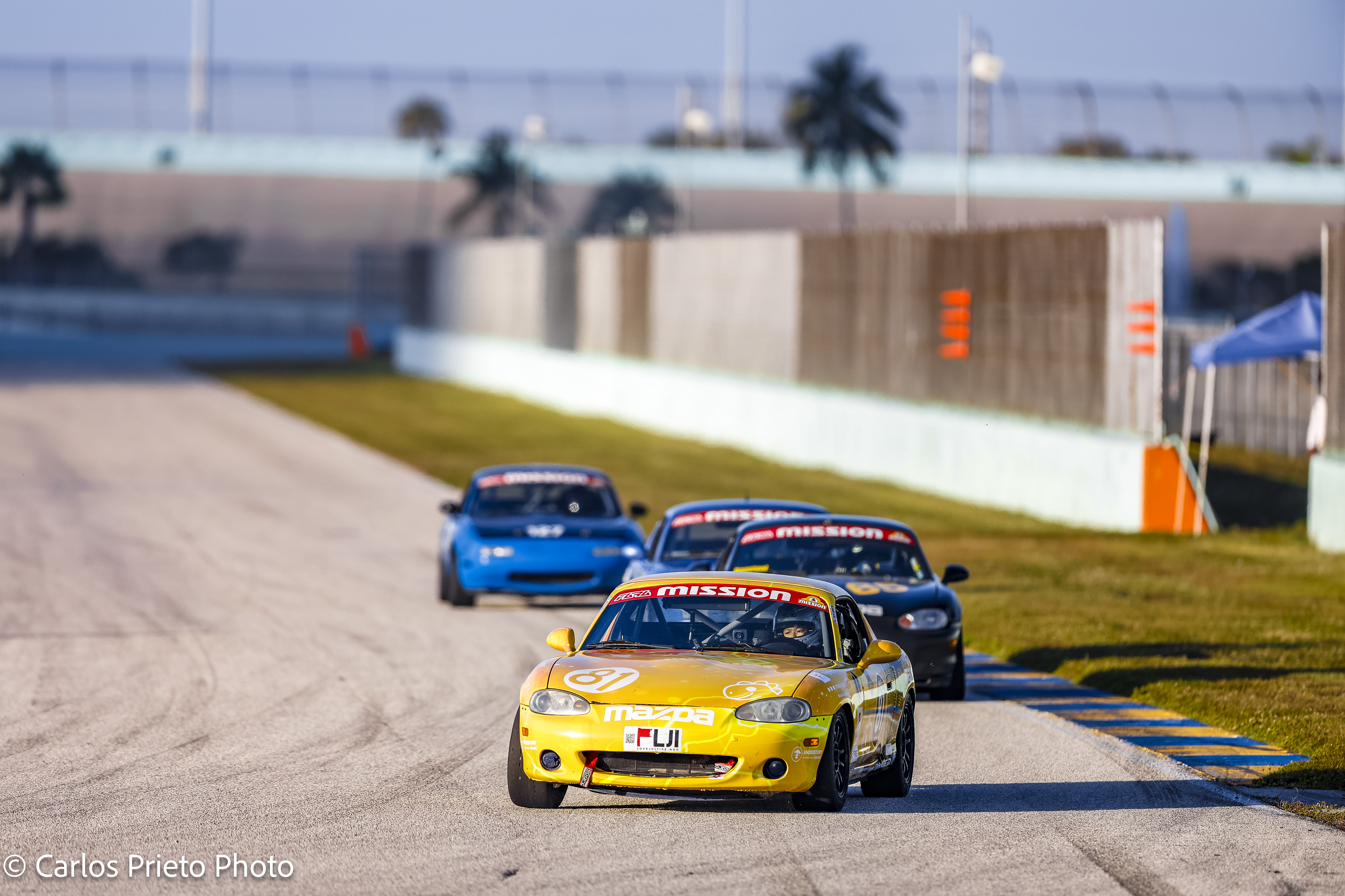 Joseph Saddington TOSHI #81 yellow Pro Spec Miata leading pack at Homestead Miami Speedway